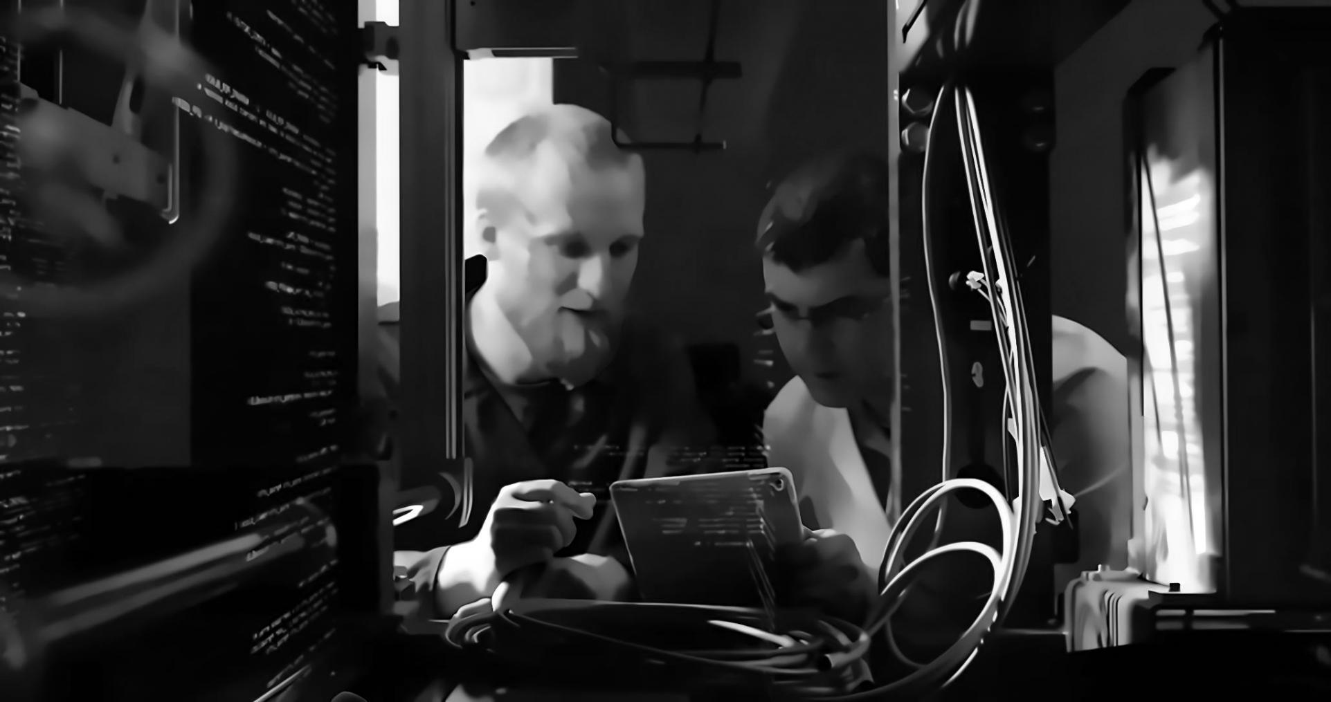 Students collaborating on blockchain development project with multiple monitors showing code and network diagrams